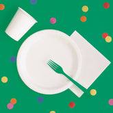 Green plastic tablecloth covering a rectangular party table