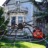 59-inch giant black Halloween spider with red eyes and poseable legs beside a large white triangular web