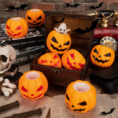 Hand squeezing a silicone pumpkin fidget toy