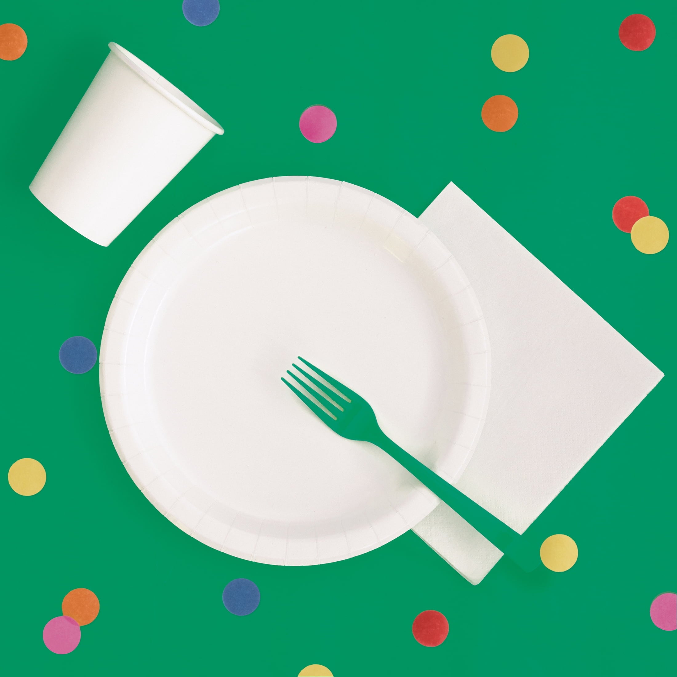Green plastic tablecloth covering a rectangular party table