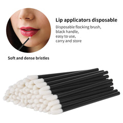 Disposable lip wand applying lip gloss to the lips
