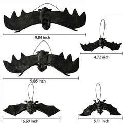 Realistic rubber bats hanging from tree branches