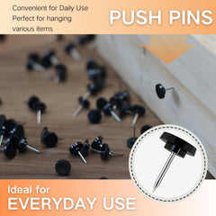 Close-up of low-profile black push pin head and steel point