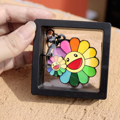 Close-up of smile flower and initial letter charm design