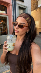 Woman wearing wide polka dot headband with messy bun